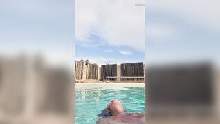 Naked swimming and smoking mature woman
